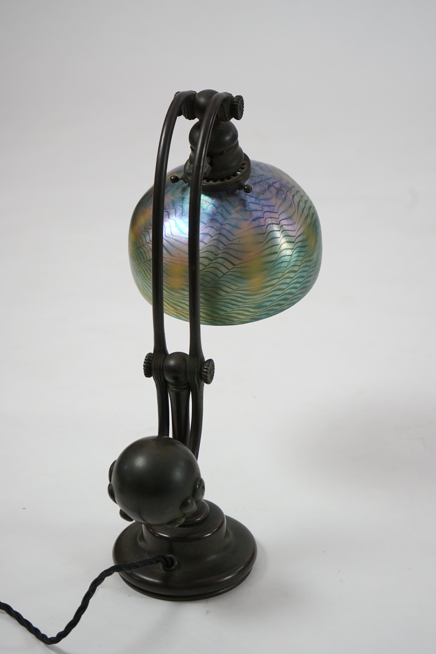 Tiffany Studios. A patinated bronze counter-balance desk lamp with ‘favrile’ glass shade, c.1905